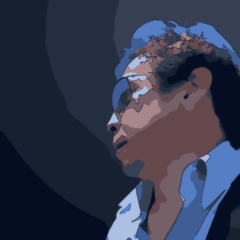 Side profile of a man wearing glasses, illustrated in blue tones.